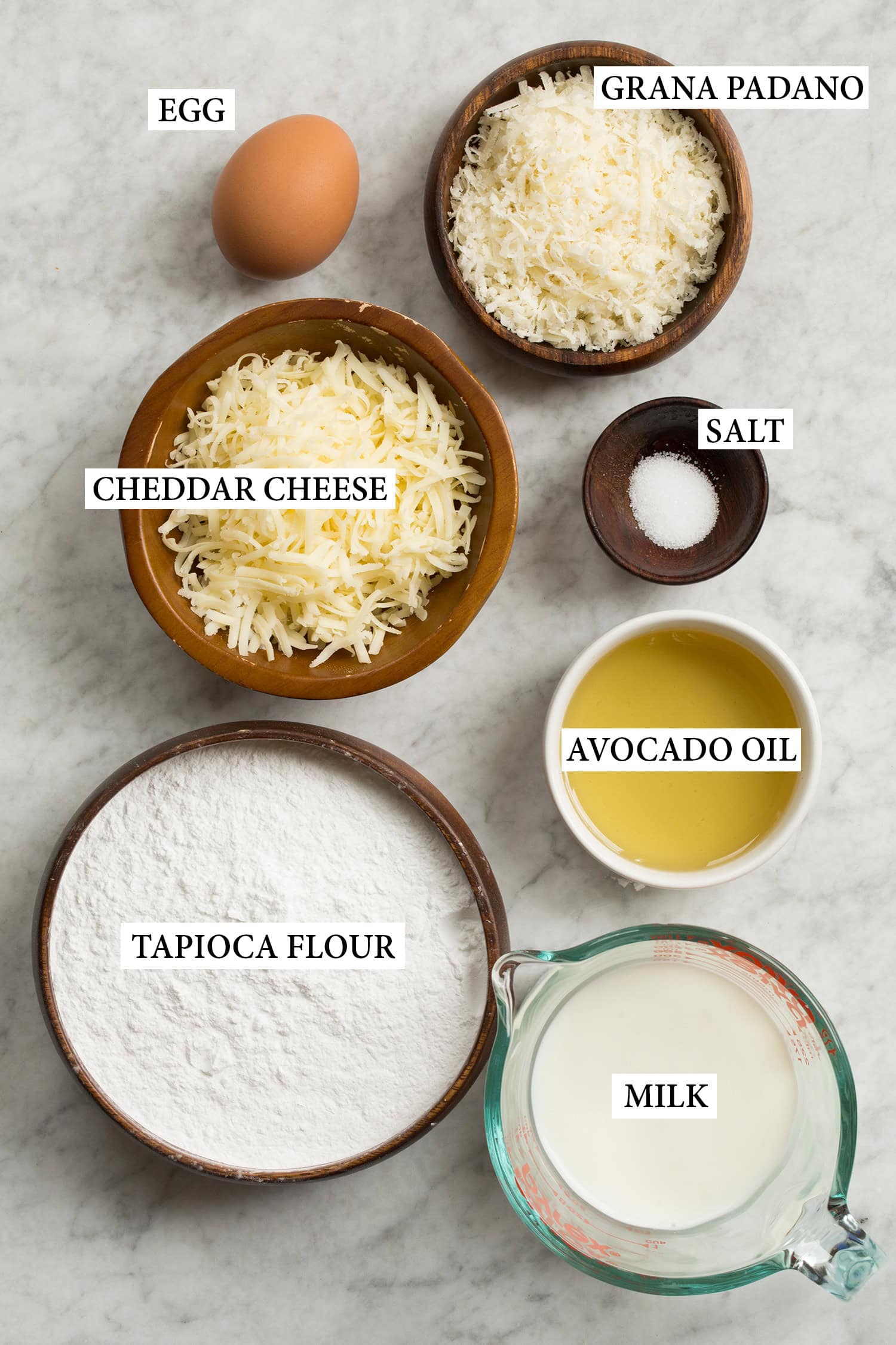 Brazilian Cheese Bread (Pão de Queijo) Ingredients used to make Brazilian cheese bread shown in various bowls.