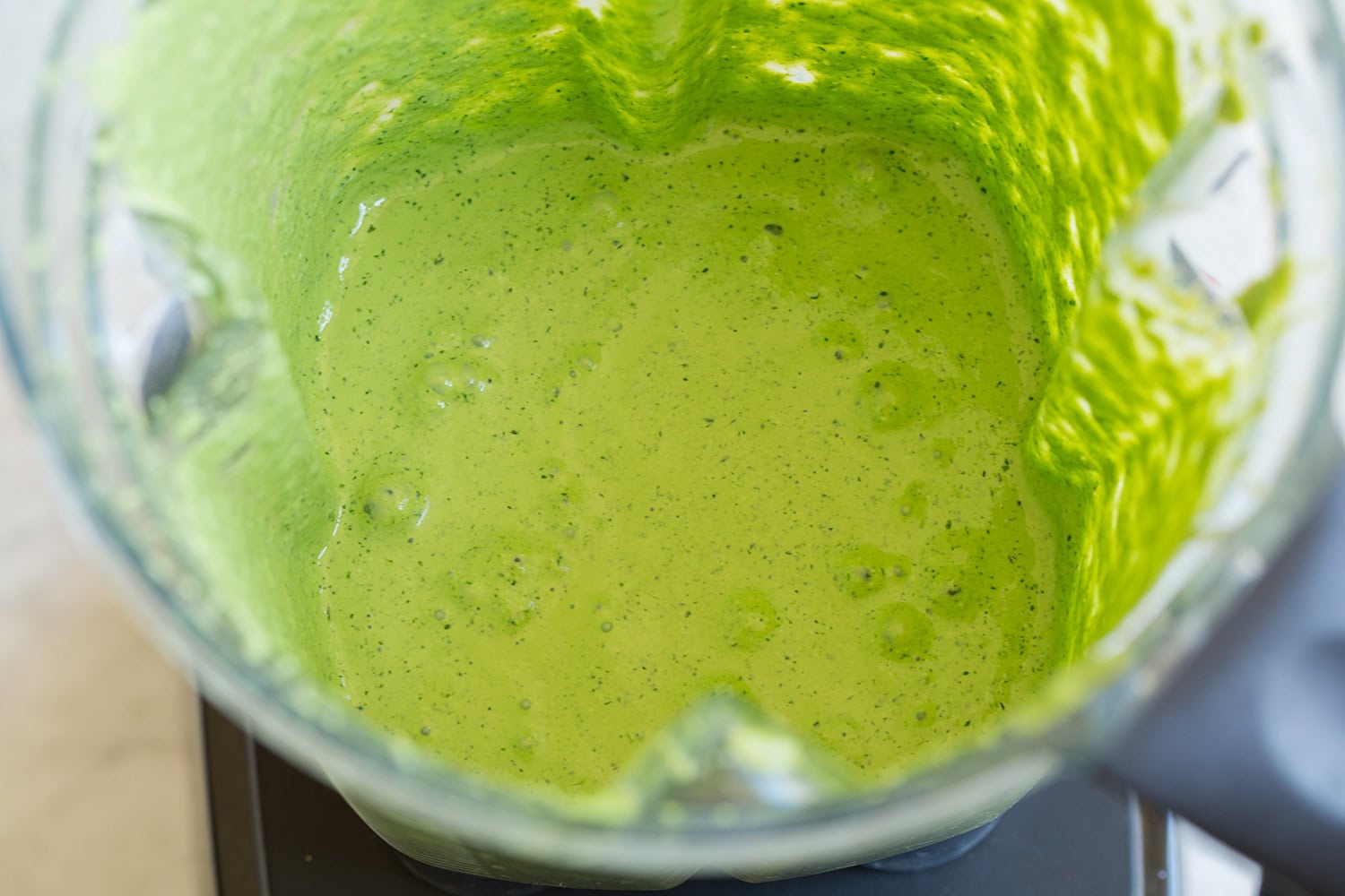 Blended aji verde sauce shown after processing in blender.