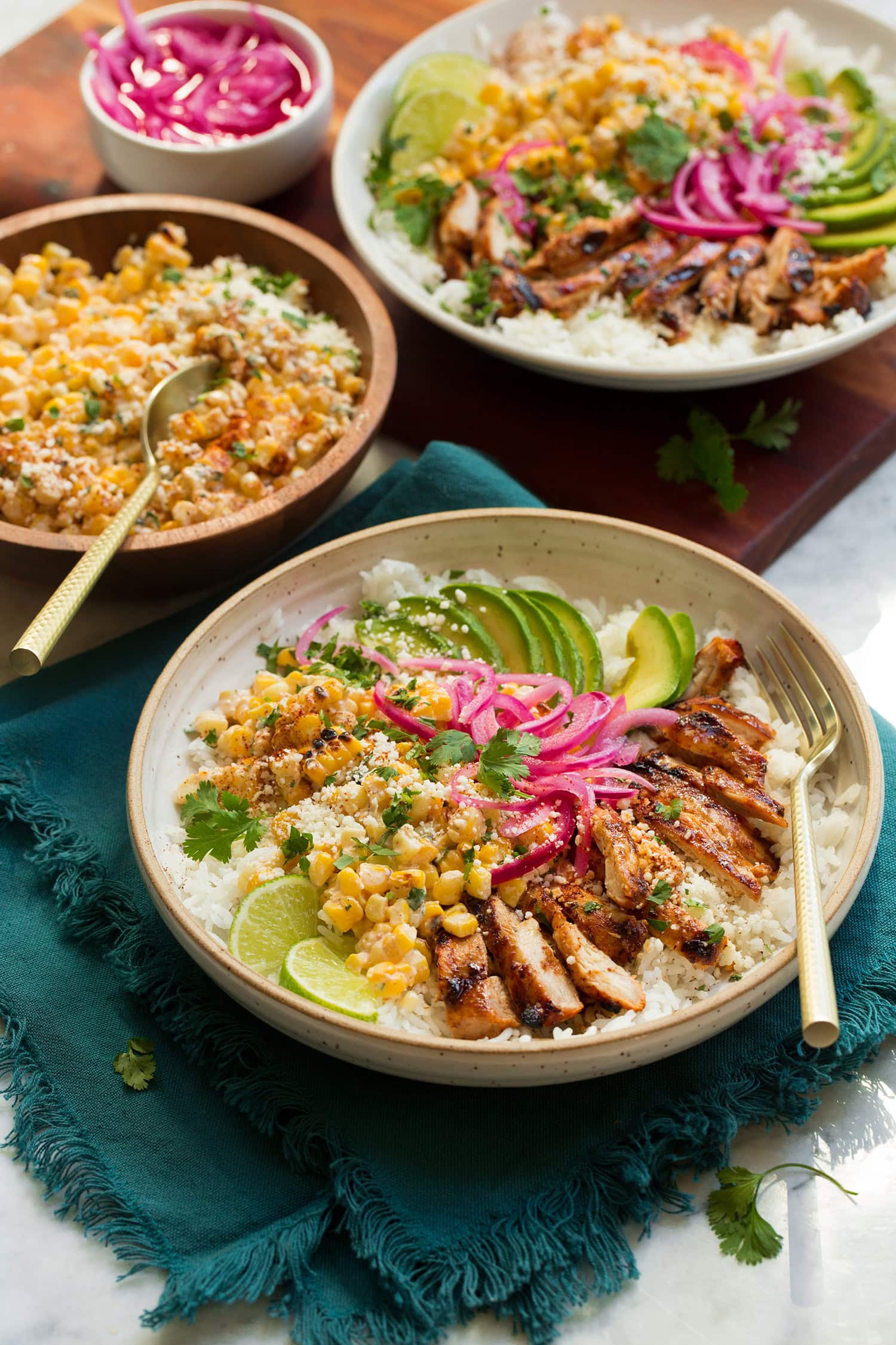 Street Corn Chicken Rice Bowl Street corn chicken rice bowl featuring grilled chicken, grilled corn, pickled red onion, cotija, avocado and spices.