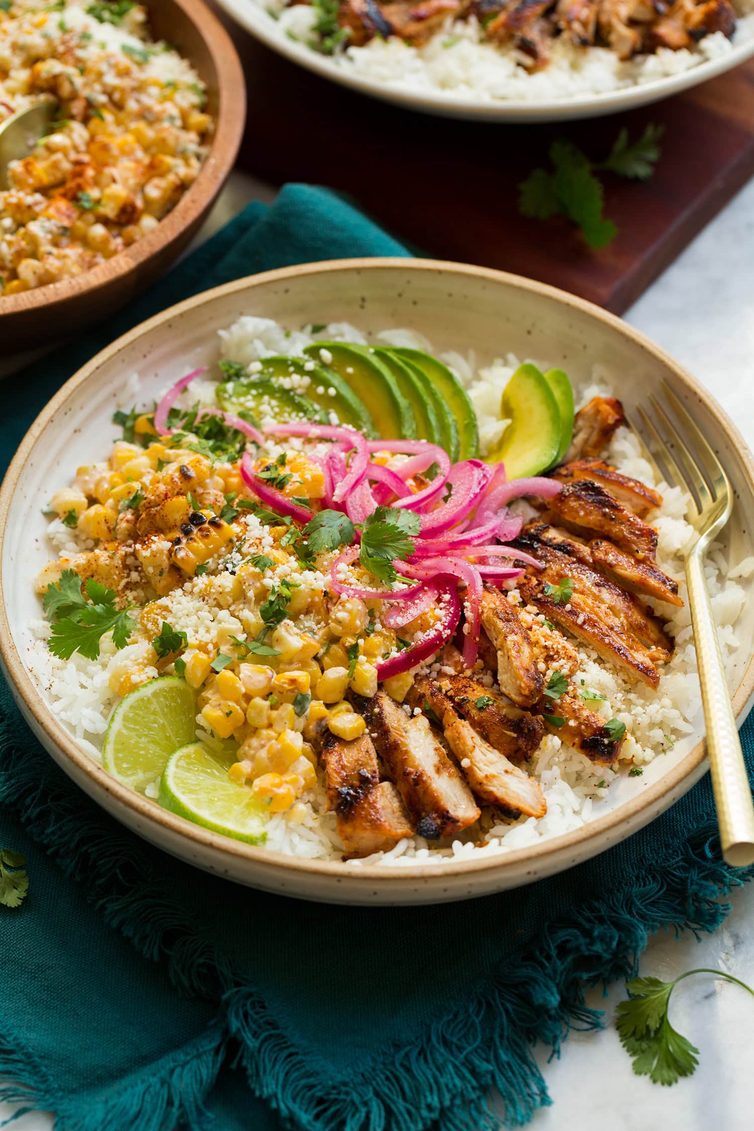 Street Corn Chicken Rice Bowl Street corn and chicken rice bowl with avocado and pickled red onions.