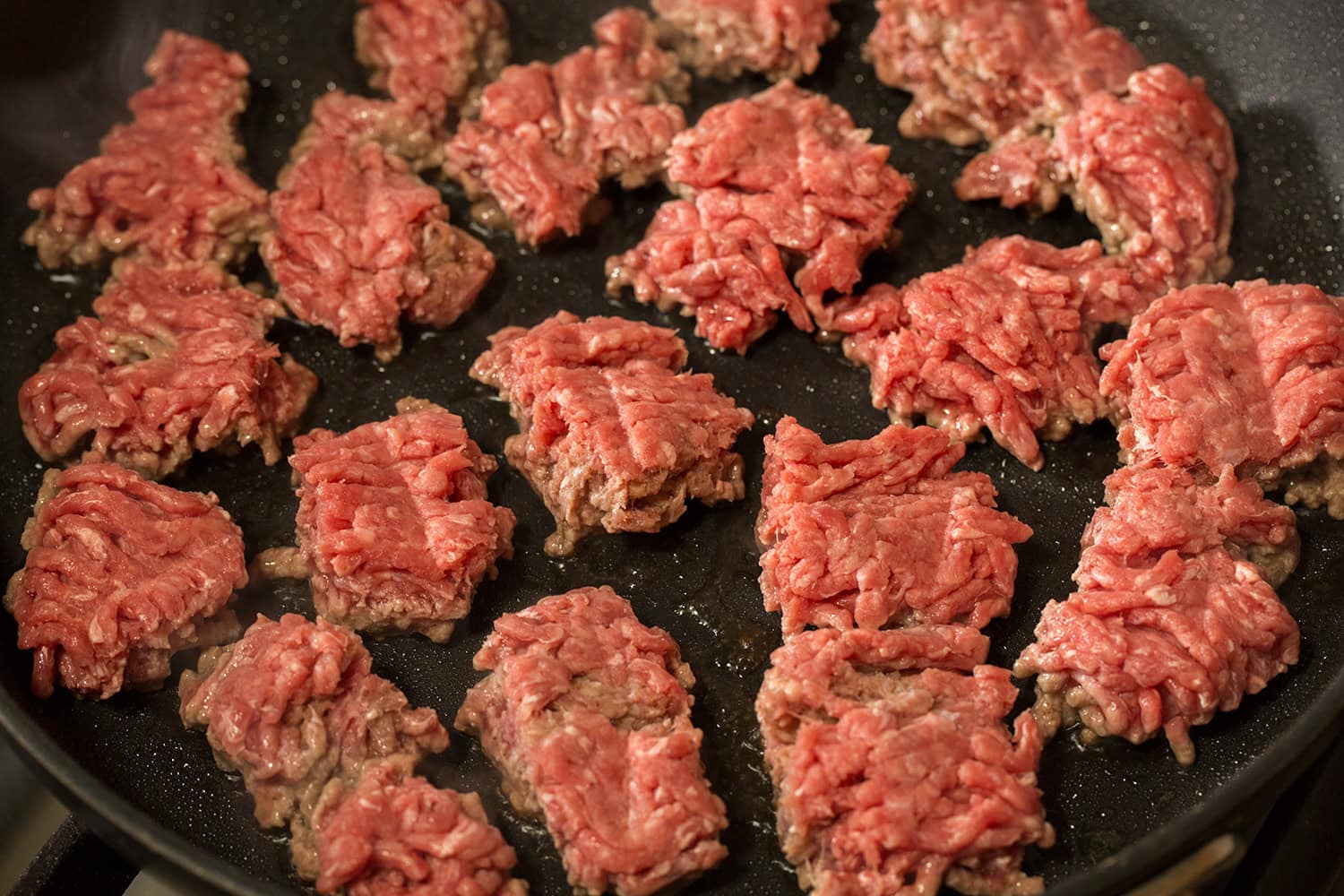 Easy Beef Burritos Raw ground beef added in chunks to skillet.